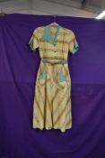 A 1930s/40s yellow seersucker day dress having green and orange stripes, smaller size.