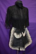 A late Victorian/Edwardian beaded apron in black with lace detail, and lace, sleeved capelet or