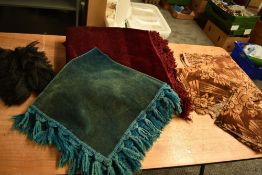 A vintage burgundy throw having tassled edge and similar smaller teal example, a roll of