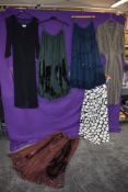 A mixed lot of vintage and retro clothing including dresses and bohemian styled skirts.