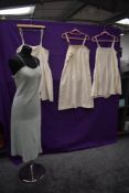 Four early 20th century silk slips, some having lace and embroidered details.