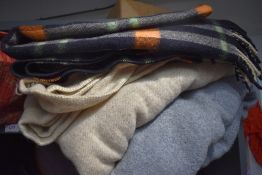 Three vintage blankets including bright checked travel rug.