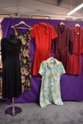 Six mixed vintage dresses, all having bright patterns, different styles and sizes.