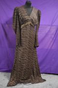 A brown 1940s evening gown having metallic gold thread running throughout, side brass zipper and