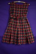 A vintage 1960s plaid mini dress having half belt to waist and side zip.