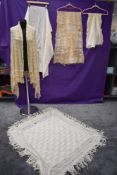 A selection of antique shawls amongst which are two knitted/ crotched examples.