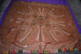 A mid 19th century paisley wool shawl having fringed edging.