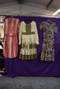A 1930s striped silk day dress, A 1950s Jima model day dress and a sheer floral late 1940s dress.