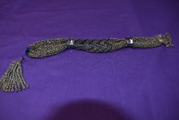 A late Georgian/early Victorian misers purse having original cut steel bands.
