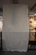 A late 19th early 20th century white bed throw having embroidered and cut work detailed sections.