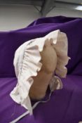 A late 19th early 20th century white cotton milk maids bonnet with blue piping.