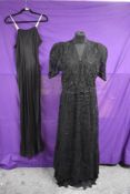 A black lace 1930s dress having separate blouse which sits slightly looser over the plain topped