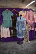 A collection of vintage and retro ladies clothing including skirt sets and dresses.