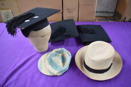 A mixed lot of vintage hats including academic, school cap and straw hat.