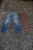 A scarce pair of American 1940s/50s ladies side zip high waisted jeans and a pair of brown slacks