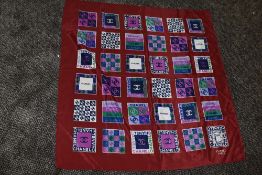 A vintage headscarf bearing the Channel logo,Having rolled edges, red ground with blue green and