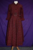 A 1950s Horrockses fashions day dress in red and black cotton having 3/4 sleeves, belted waist and