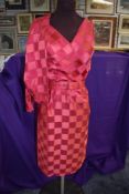 A bright pink 'Polly Peck' checked 1950s dress with matching bolero jacket and belt.