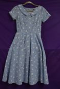 A vintage 1950s blue and white striped cotton day dress with daisy pattern,having boat neckline with