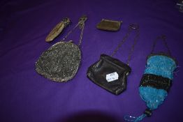 A selection of antique coin purses including beaded and leather examples.