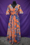 A vintage Batik evening dress having orange ground with bold blue and white design, Made in