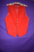 A pillar box red Liberty waistcoat having wool front and Liberty fabric to back.