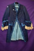 An antique dark blue silk jacket with embroidery in blue hues and lace to cuffs, appears to be