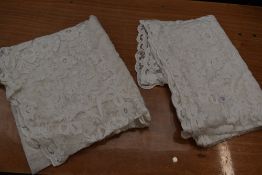 A long pair of early 20th century tulle curtains, intricate floral detailing throughout.
