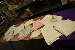 A selection of vintage and antique table linen including embroidered examples, damask and more.