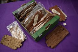 A box full of unworn vintage leather and similar driving gloves, around 40 pairs.