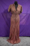 A late 1930s/ early 1940s pink and black evening gown having metallic copper thread running