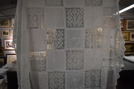 A late 19th early 20th century white bed throw having embroidered and crotchet panels.