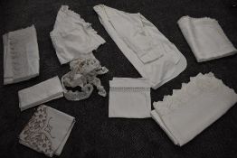 A collection of antique table linen including damask, crotchet edging, a gents 1930s nigh shirt
