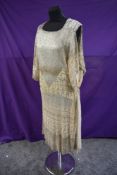 A cream 1920s Assuit/tulle bi telli flapper dress having silk lining.