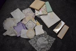 A selection of boxed bed and table linen and assorted cloths and mats, some embroidered other having