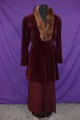A burgundy velvet jacket having belted waist and coney collar and a similarly collared skirt, not