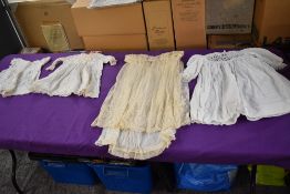 A small collection of intricate childrens garments.