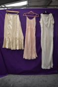 A trio of early 20th century garments, a silk petticoat,a under slip and a nightdress.