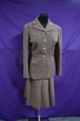 A brown and beige herringbone wool ladies two piece skirt suit by Jaeger.
