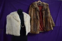 A vintage fur coat and a white 1940s capelet.