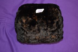 A small early 20th century mole skin or similar fur muff.