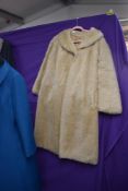 A 1960s jacket and dress set in teal blue, a Wool swing coat with astrakhan or similar collar and