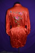 A vintage red kimono dressing gown having floral embroidery.