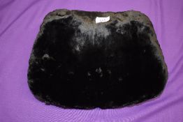 A late 19th/early 20th century mole skin or similar fur muff lined with white coney.