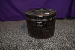 An antique metal hat tin.
