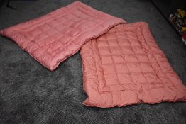 Two vintage rose pink single eiderdowns.