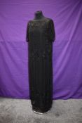 A 1920s black beaded flapper dress, sheer beaded overlay with integrated silk slip.