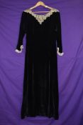 A late 1930s black velvet dress having intricate lace to cuffs and collar, side brass zip,in a
