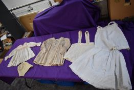 A selection of childrens antique dresses having smock detail and a childs night cap.