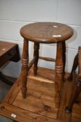 A traditional part oak stool having turned frame